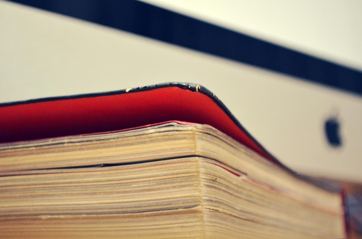 Close-up of book pages with red cover