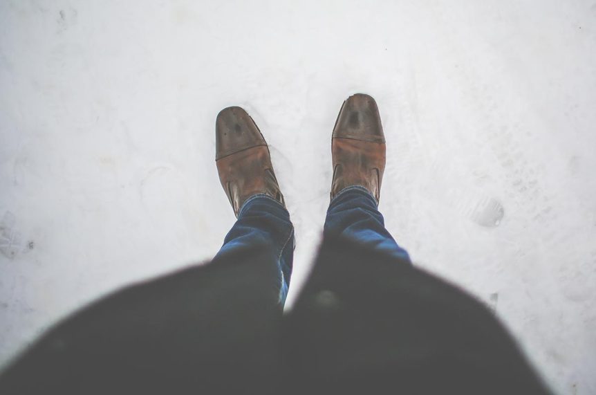Overhead view of brown shoes and jeans