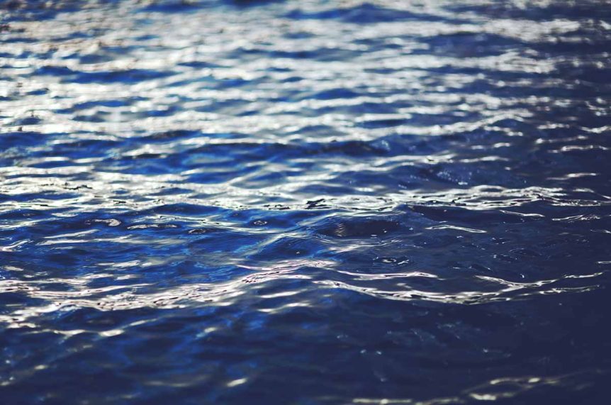 Rippling blue water surface with reflections