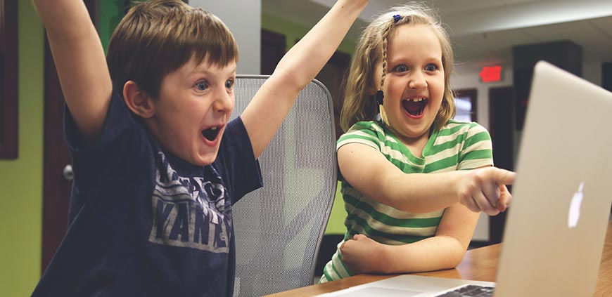 Two children watching something on the laptop